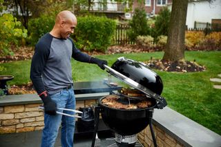 man cooking on bbq