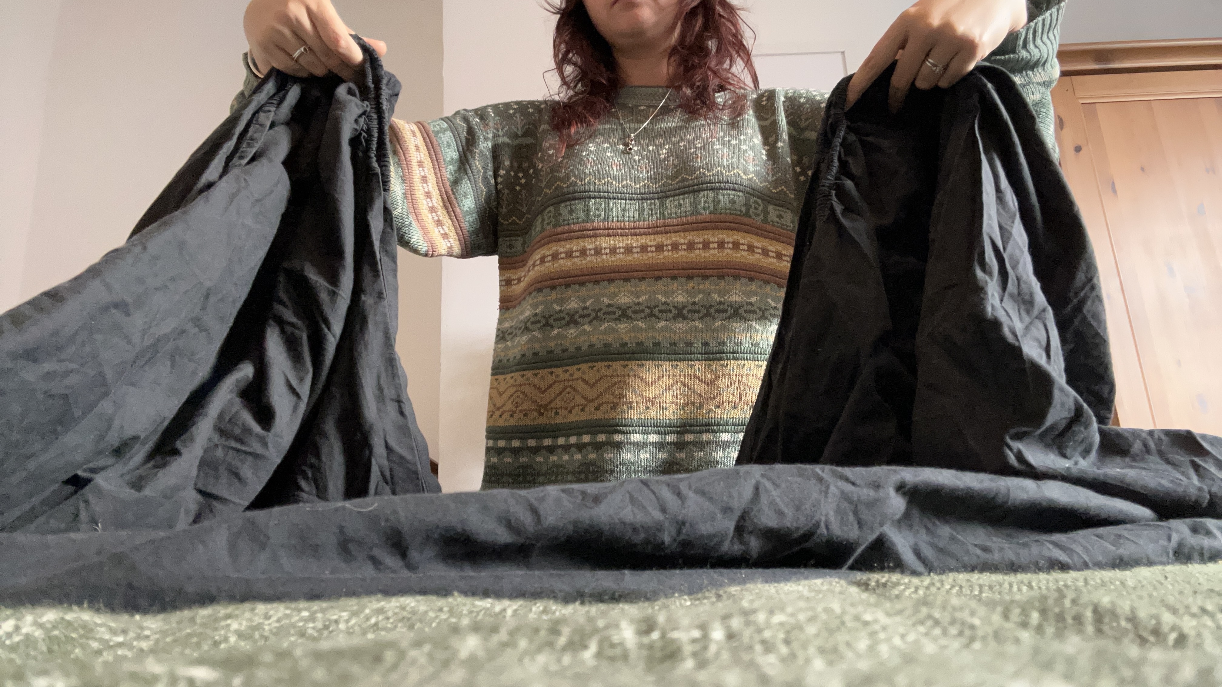 Tom's Guide Sleep Features Editor folding all the corners of a fitted sheet together