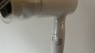 Close up of the Panasonic nanoe™ Travel Hair Dryer (EH-NA2C-W) temperature settings