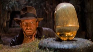 Indiana Jones contemplates how to steal the gold egg in Raiders of the Lost Ark