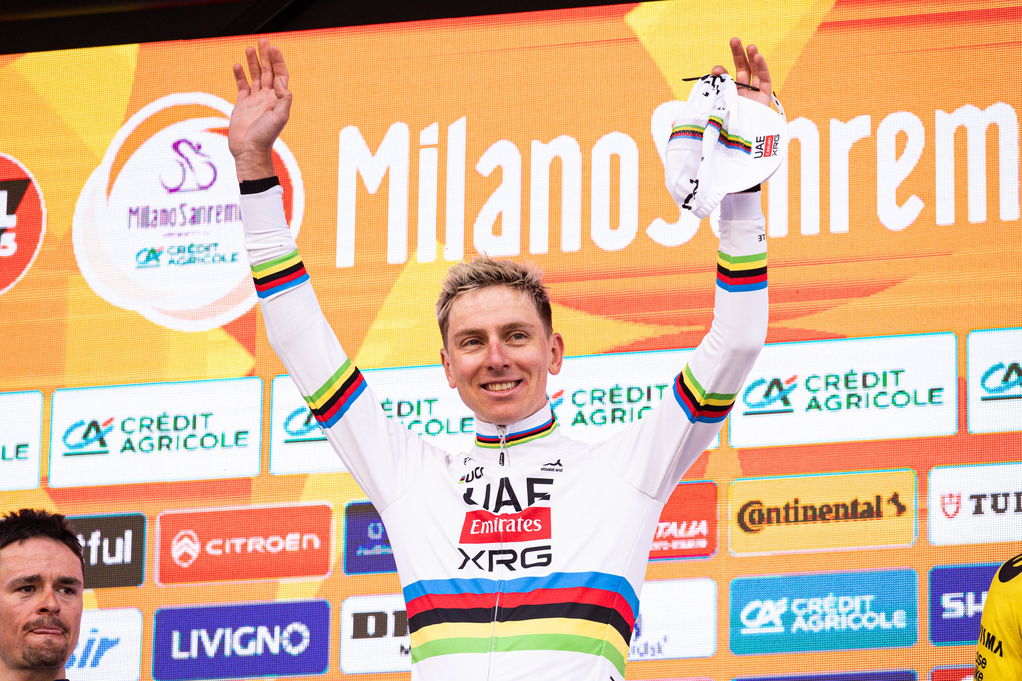 Tadej Pogacar stands in 1st place on the podium with Carlos Sainz at Via Roma in Sanremo, Italy, on March 21, 2026, during the Milano Sanremo 2026. (Photo by Tommaso Berardi/NurPhoto)