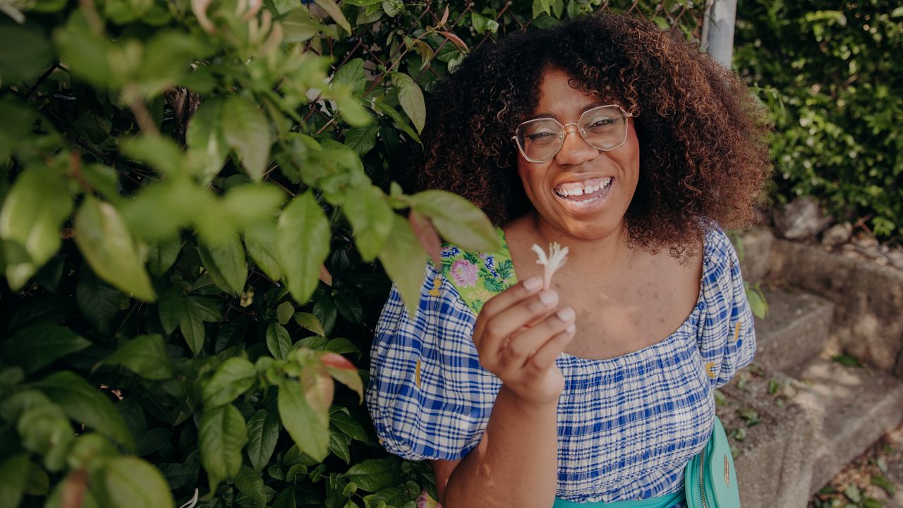 Urban forager Alexis Nelson in front of a bush