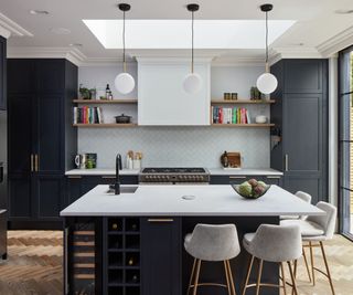 A dark blue and white kitchen with a square kitchen island