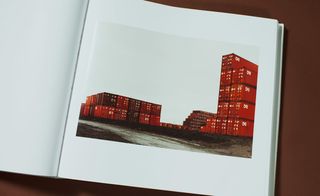 The image inside the book shows stacked red containers.