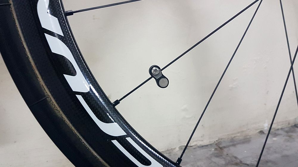 An SRM Speed Sensor magnet is attached to the spoke with the sensor on the fork leg