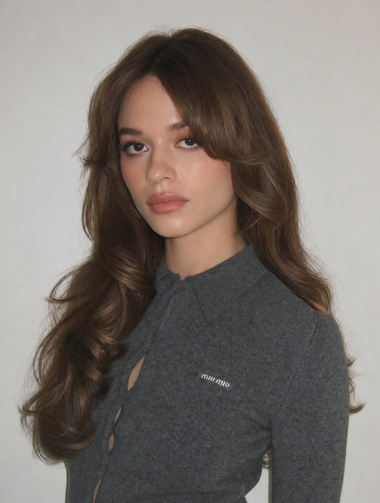 An image of Sadie Soverall with curtain bangs and long hair.