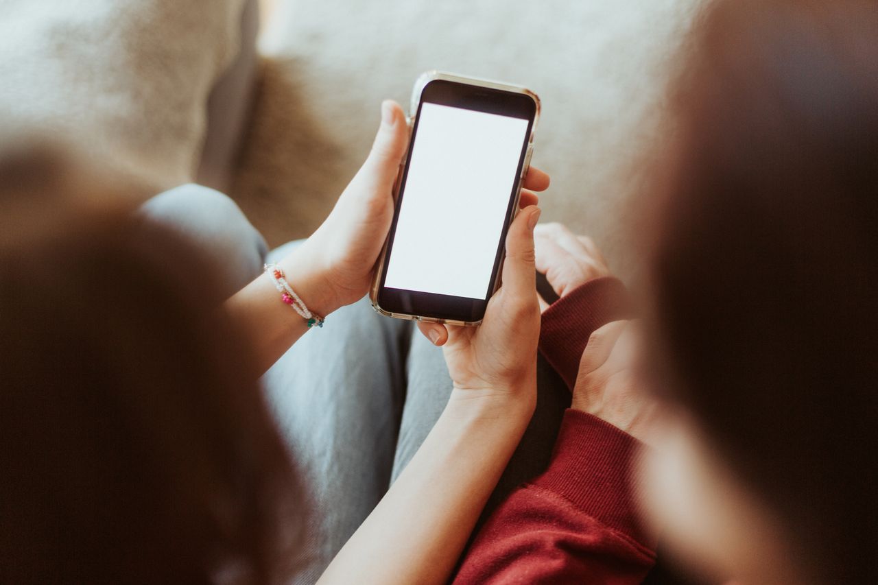 Two people holding iPhones