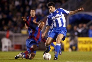 Deportivo La Coruña's Juan Carlos Valeron is tackled by Barcelona's Ronaldinho in a La Liga game in 2004.