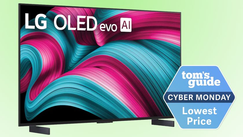 The 42-inch LG C5 OLED TV displaying an abstract image. Next to the TV is a badge that reads: &quot;Tom&#039;s Guide Cyber Monday Lowest Price&quot;.