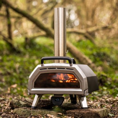 Ooni Karu 16 Multi-Fuel Pizza Oven being used in the woods