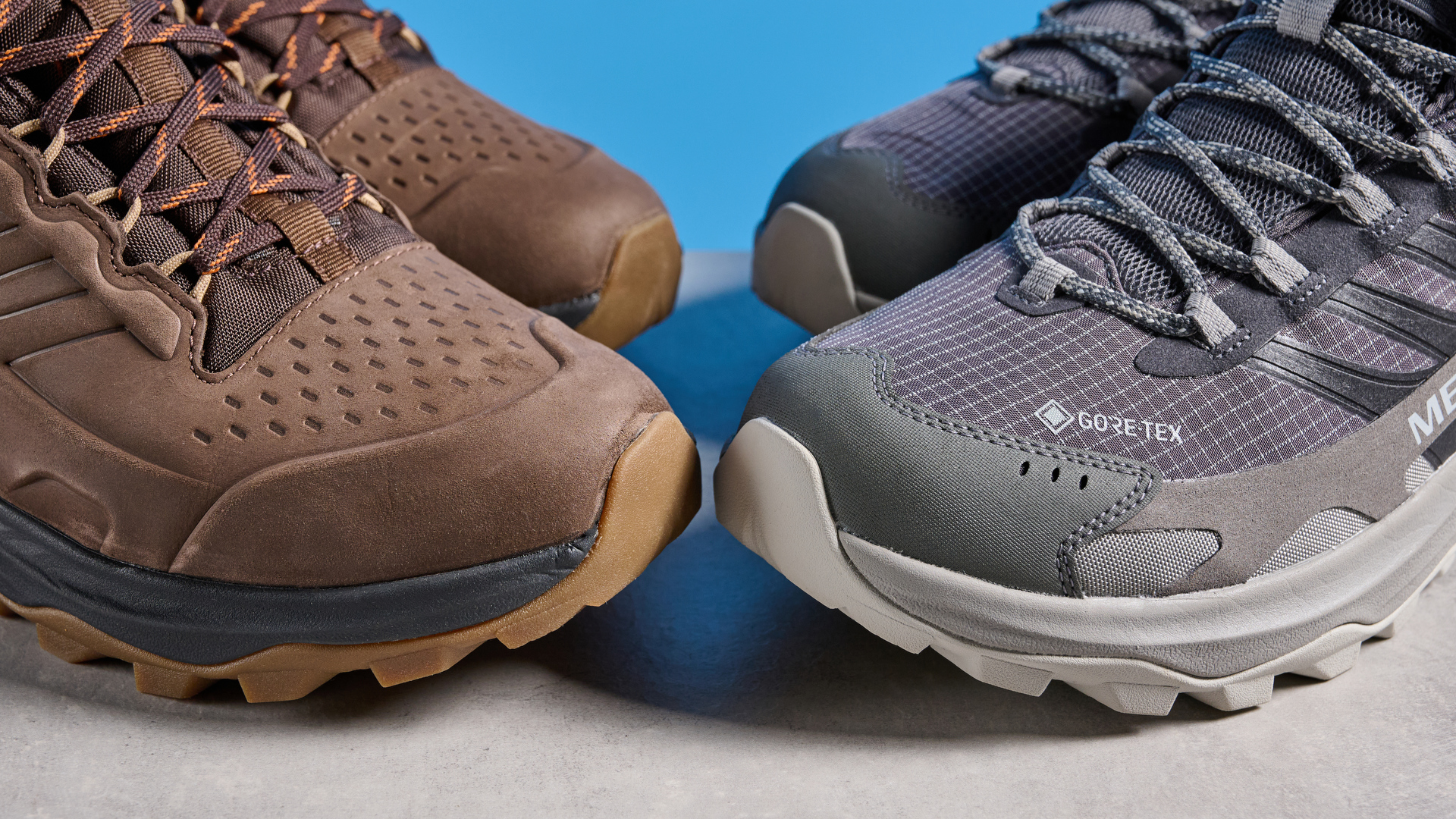 A photo of the Merrell Moab Speed 2 boots against a blue background
