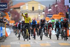 Olav Kooij in yellow celebrates winning stage four of Tirreno-Adriatico