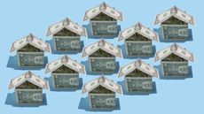 Several houses made from dollar bills are lined up.