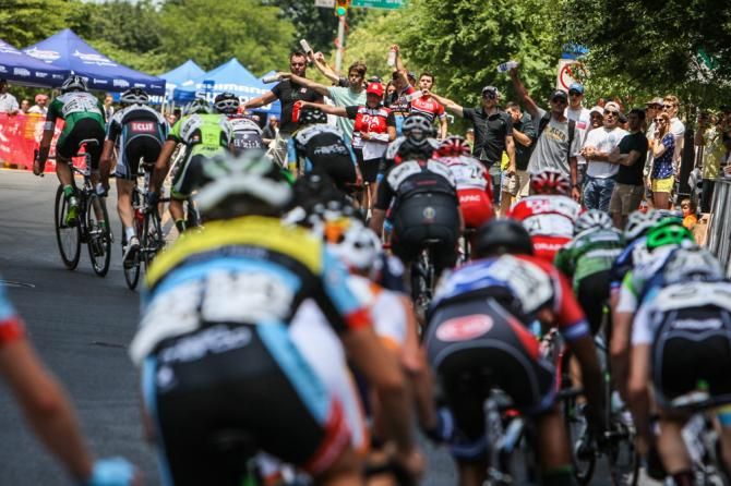 Riders enter the feed zone on the back side of the course.