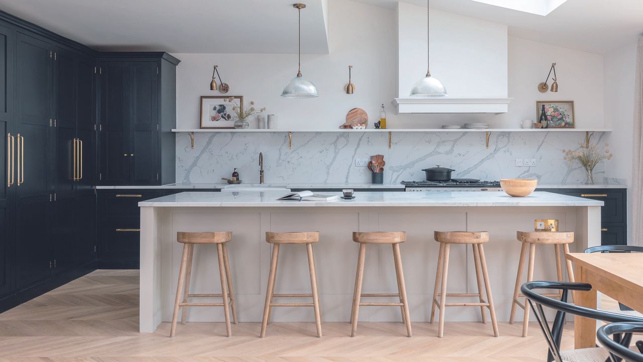 Large open plan kitchen with island and dual-tone palette.