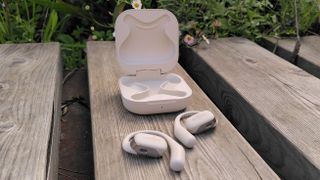 Shokz OpenFit headphones outside charging case