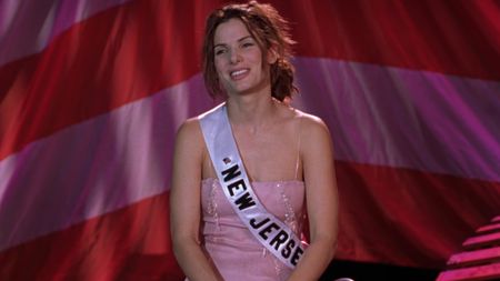 Sandra Bullock as Gracie on stage in a gown in Miss Congeniality.