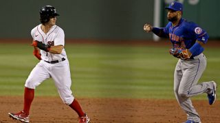 Red Sox Andrew Benintendi is chased between bases by Mets Robinson Cano