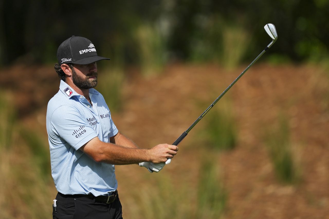 Cameron Young lines up an iron shot
