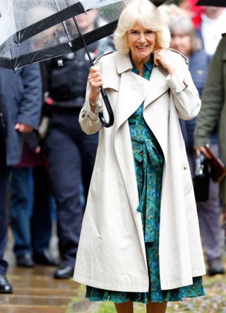 Queen Camilla shelters under as she arrives for a visit to Lamb House, the former home of novelists Henry James, Rumer Godden and E. F. Benson on May 16, 2024 in Rye, England