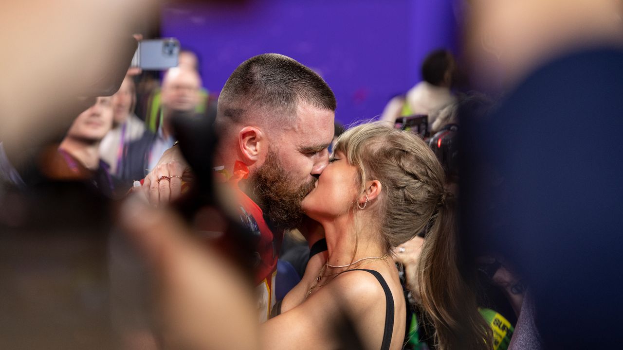 ravis Kelce #87 of the Kansas City Chiefs celebrates and kisses Singer Taylor Swift following the NFL Super Bowl 58.