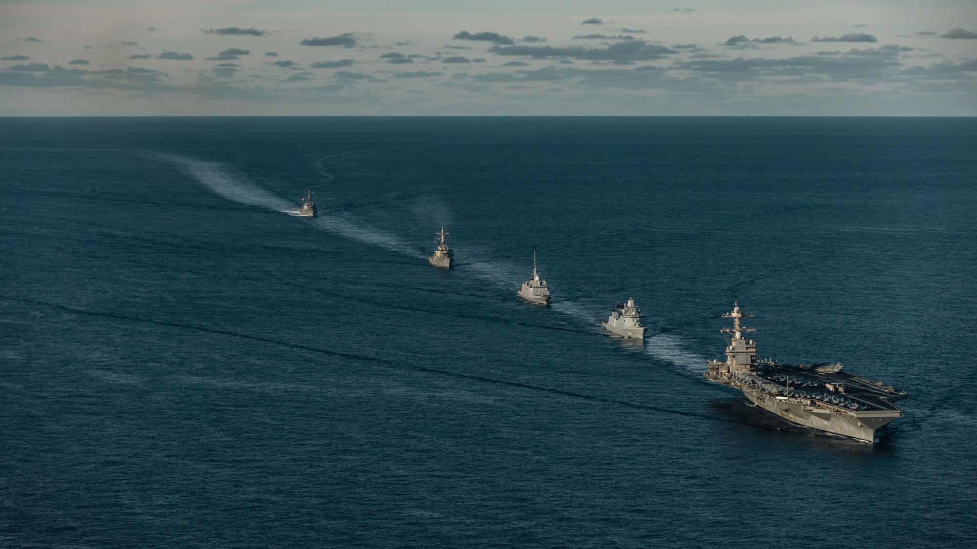 USS Gerald R. Ford and support ships process through the North Sea