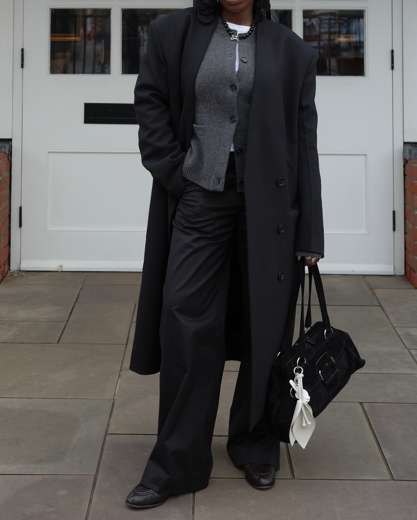 Danielle in tailored trousers and cardigan