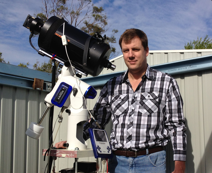 Amateur comet hunter Terry Lovejoy of Thornlands, Australia stands with the telescope and camera he used to discover the sungrazing comet C/2011 W3 (Lovejoy).