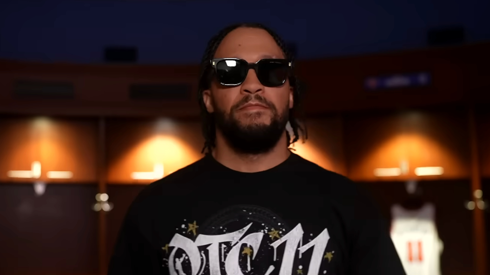 Jalen Brunson walks to the ring at Saturday Night's Main Event with sunglasses on.