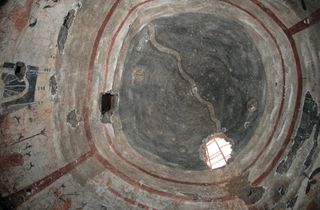 The dome ceiling of the 1,500-year-old tomb, which was discovered in Shuozhou City, China, is painted dark gray to "signify the infinite space of the sky." A silver river, with waves, weaves across the sky representing the Milky Way galaxy. Stars can be seen and the sun is represented at center-right and the moon at center-left.
