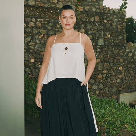 model wears white top and black balloon pants.
