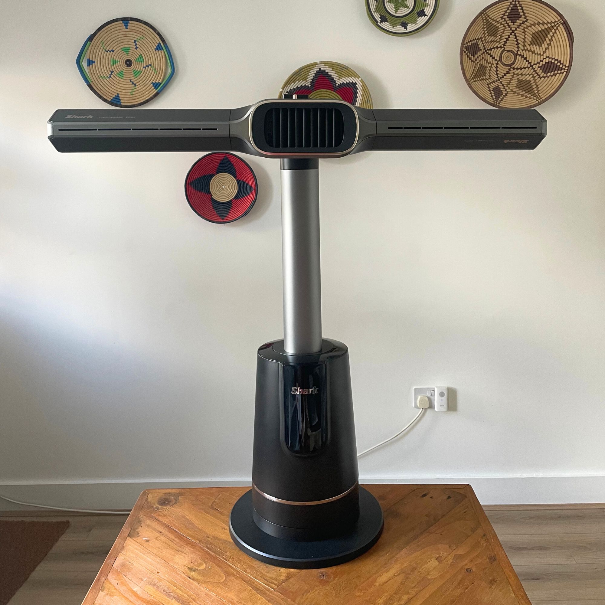 Shark TurboBlade Cool + Heat TH200UK sitting on a wooden table, in front of a white wall