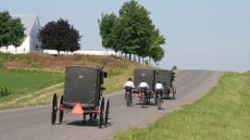 Amish traveling by bike and horse and carriage