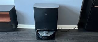 The Ecovacs Deebot X1 Omni in its docking station on a hard floor