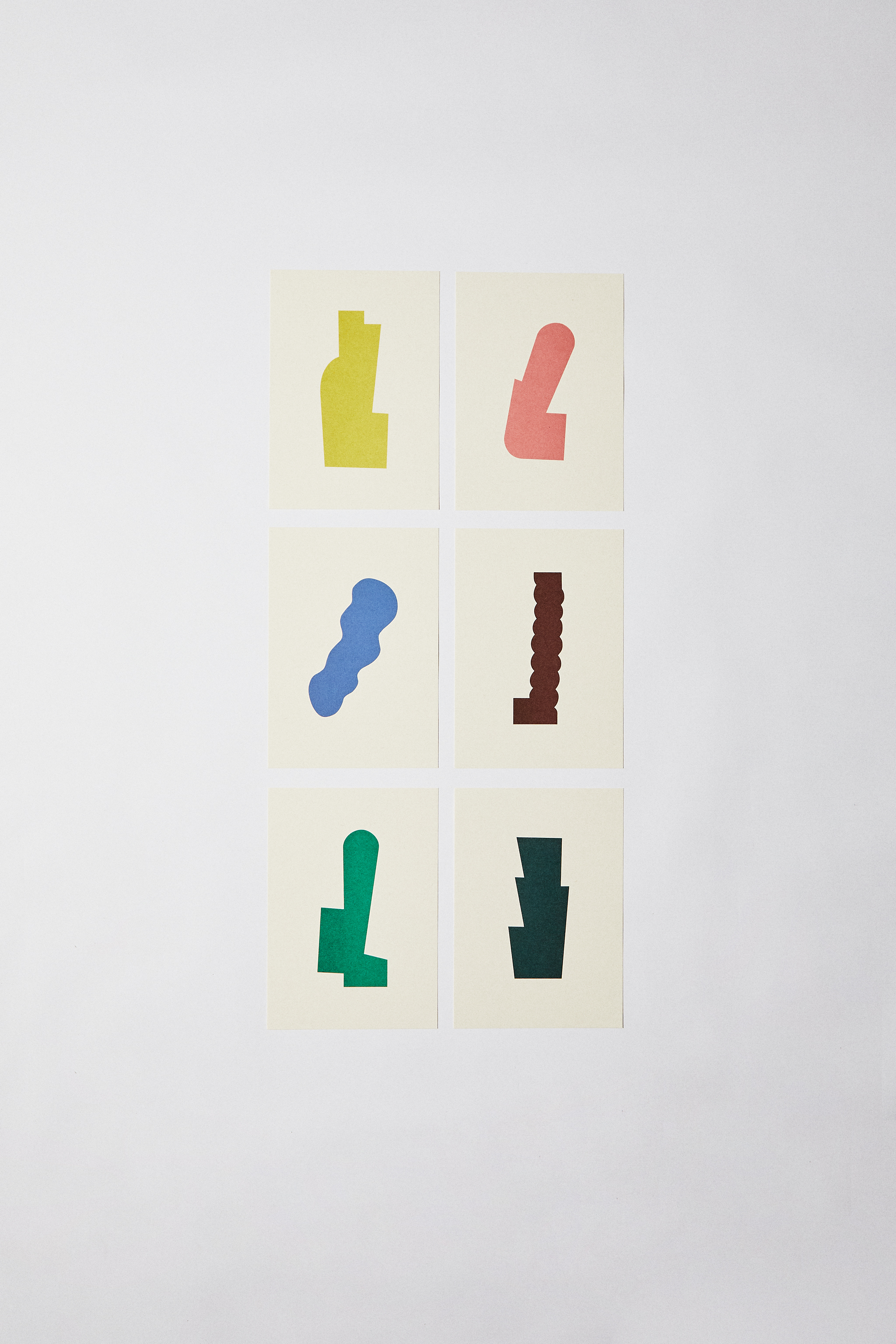 Framed posters with abstract geometric shapes in yellow, blue, burgundy, green and pink