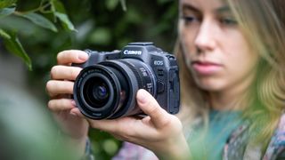 Canon R8 vs R6 Mark II: Canon EOS R8 in use by a woman