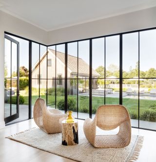 a minmalist sunroom with a pair of chairs