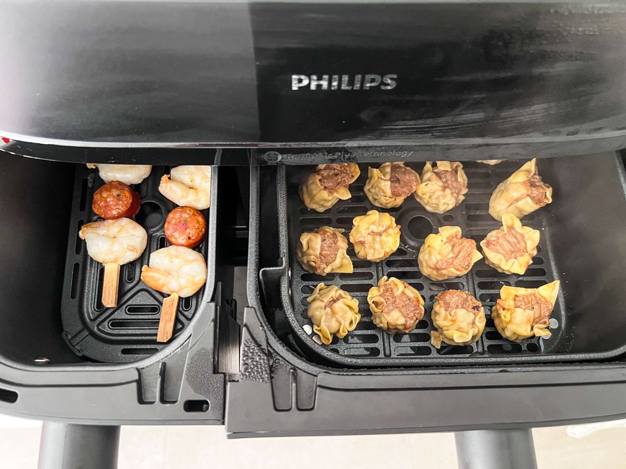 Steamed dumplings and air-fried skewers in the Philips 5000 Series Dual Basket Air Fryer XXL Steam drawers