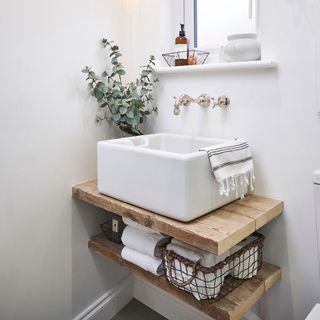 Rectangular hand basin on wooden shelf