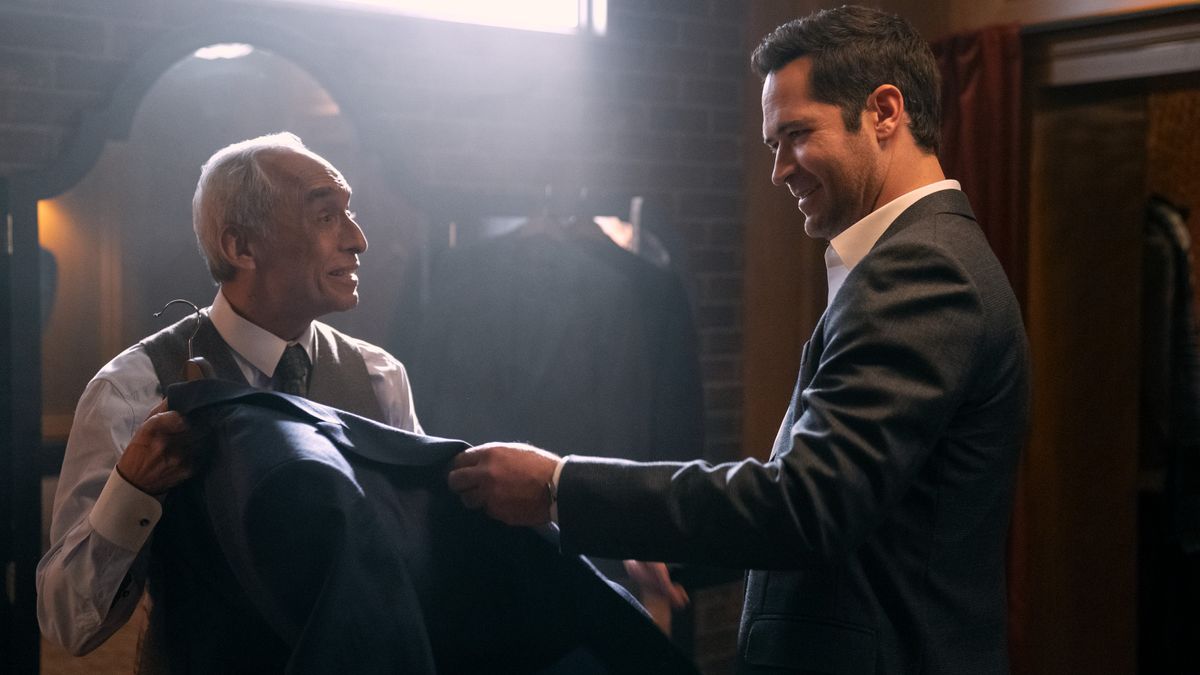 Rudy Quintanilla and Manuel Garcia-Rulfo as a taylor and Mickey in a suit store in The Lincoln Lawyer season 2 episode 5