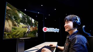 LG Display monitor being played by gamer wearing headset 