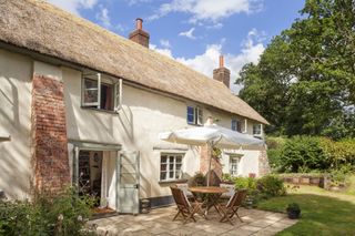 thatched cottage patio dining area