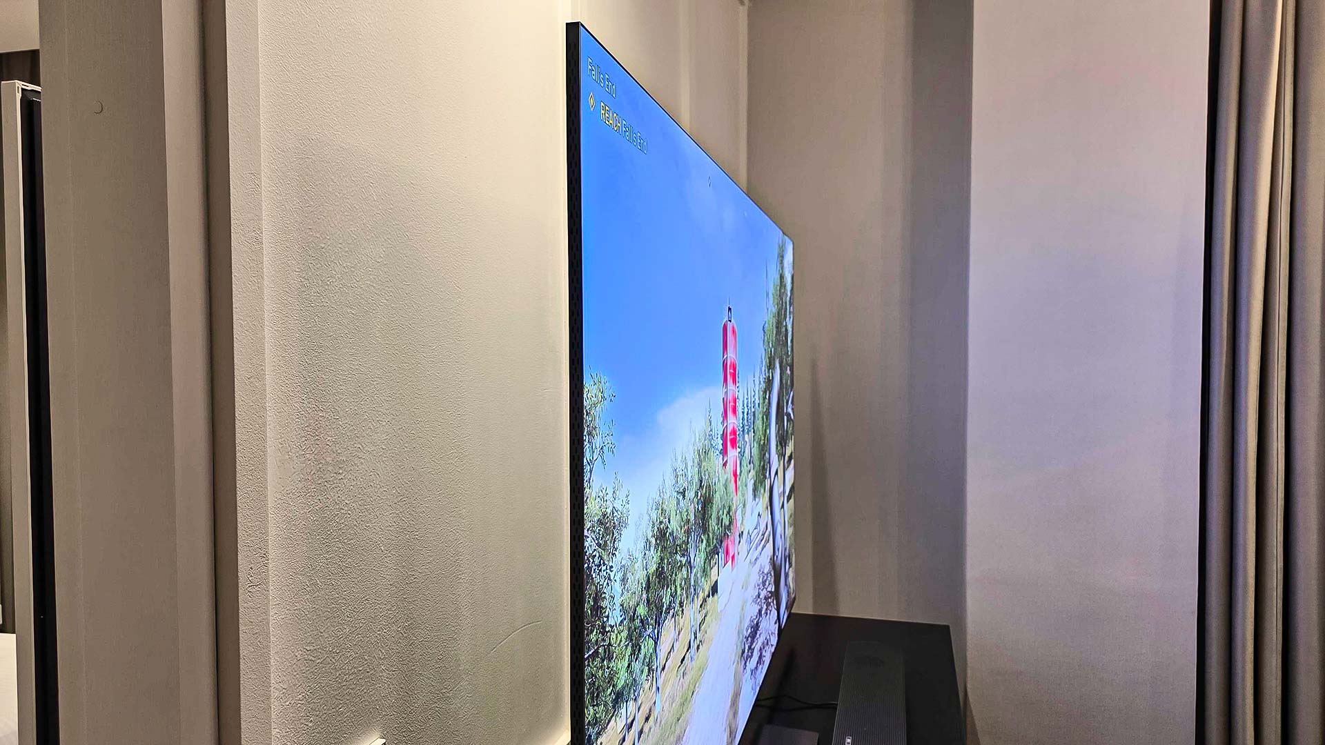 A Samsung QN990F on a TV stand.