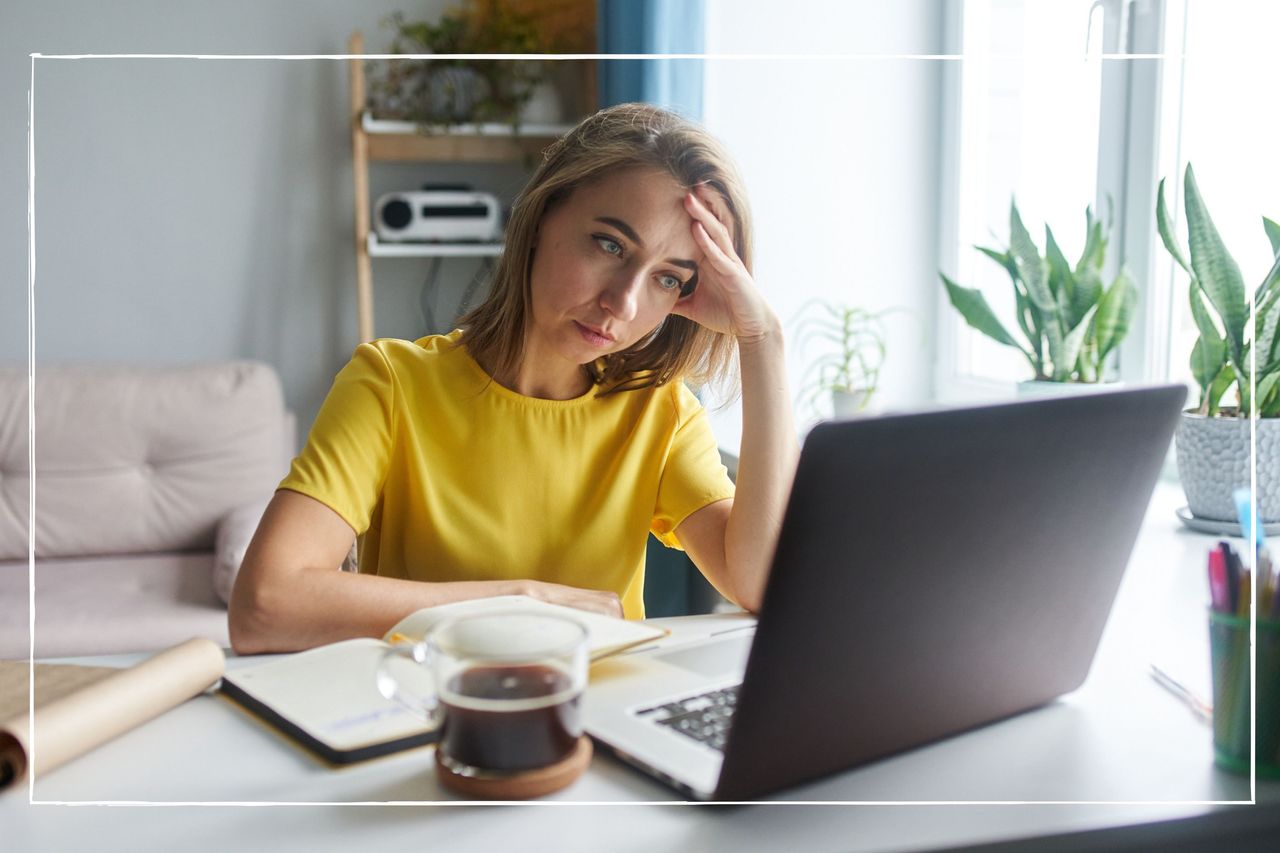 A 35-year-old woman in a bright yellow jacket is sitting in front of a laptop in emotional tension. The concept of working from home, freelance