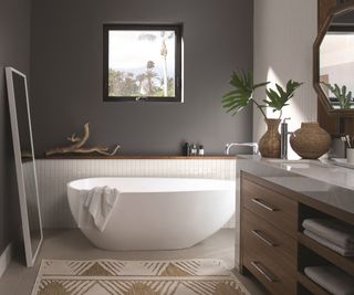 modern grey bathroom with oval freestanding bath and half wall paneling