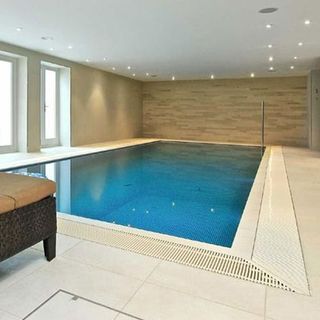 room with swimming pool and white tiled flooring