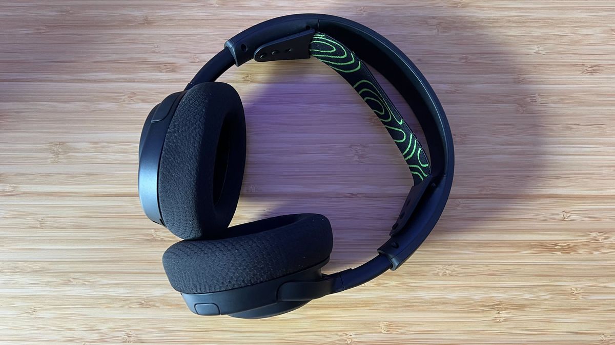 SteelSeries Arctis Nova 5 Wireless headset laying on a wooden desk
