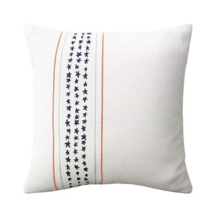 White throw pillow with stars embroidered