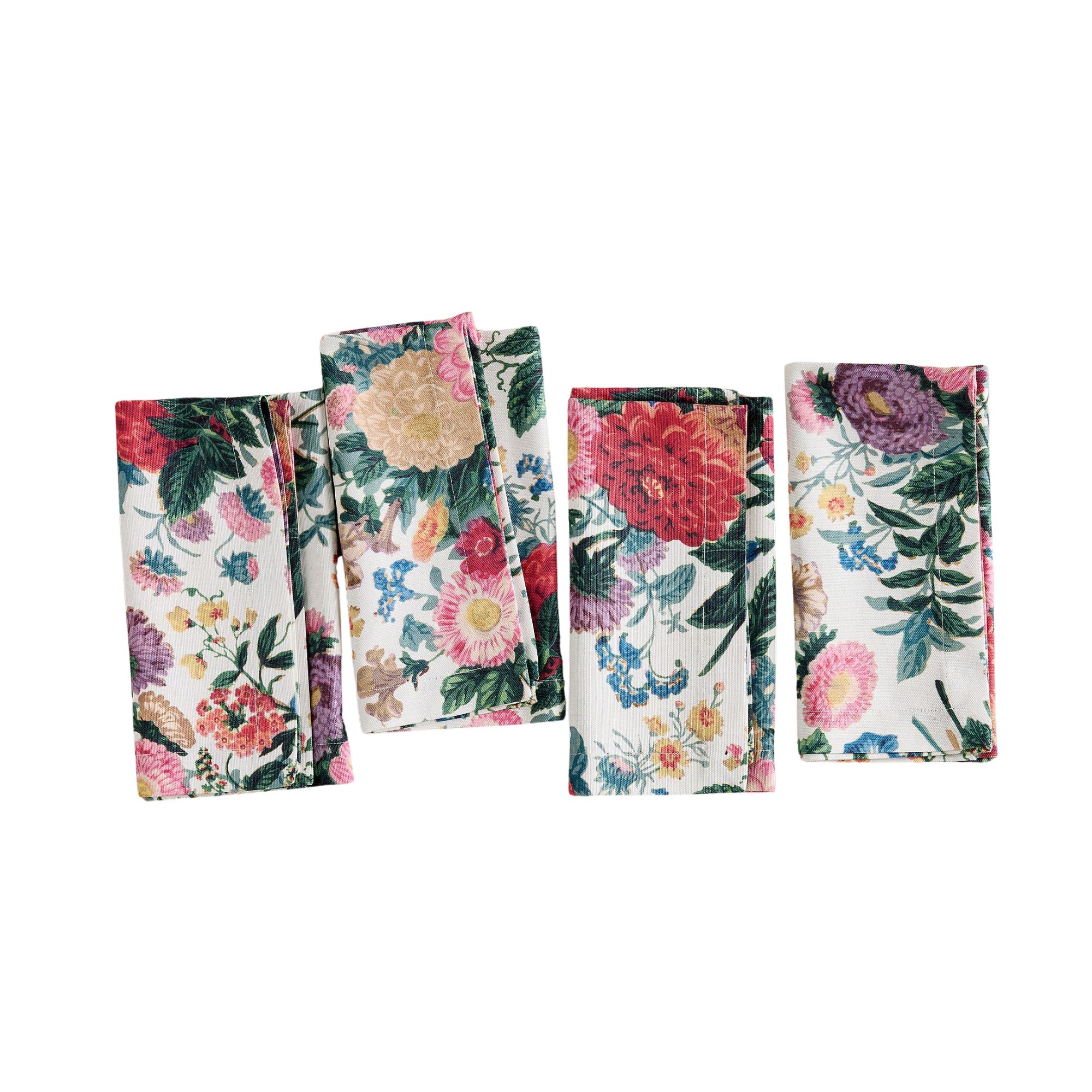 Four rectangular napkins with red and purple flowers on them and dark green leaves
