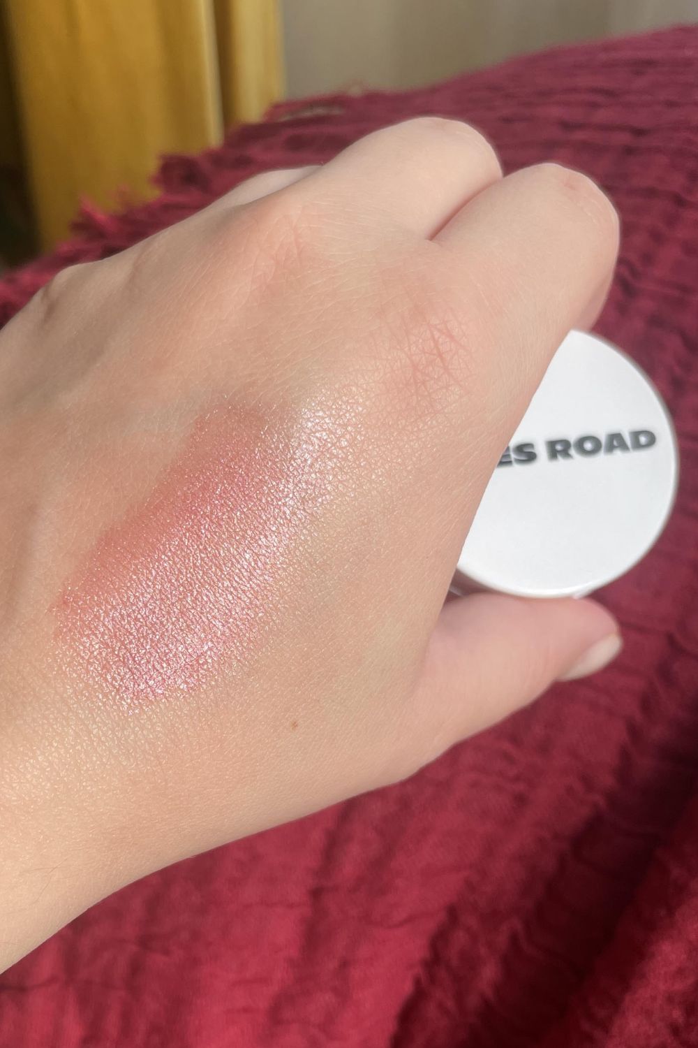 Valeza swatching the Miracle Balm in the shade Pinched Cheeks